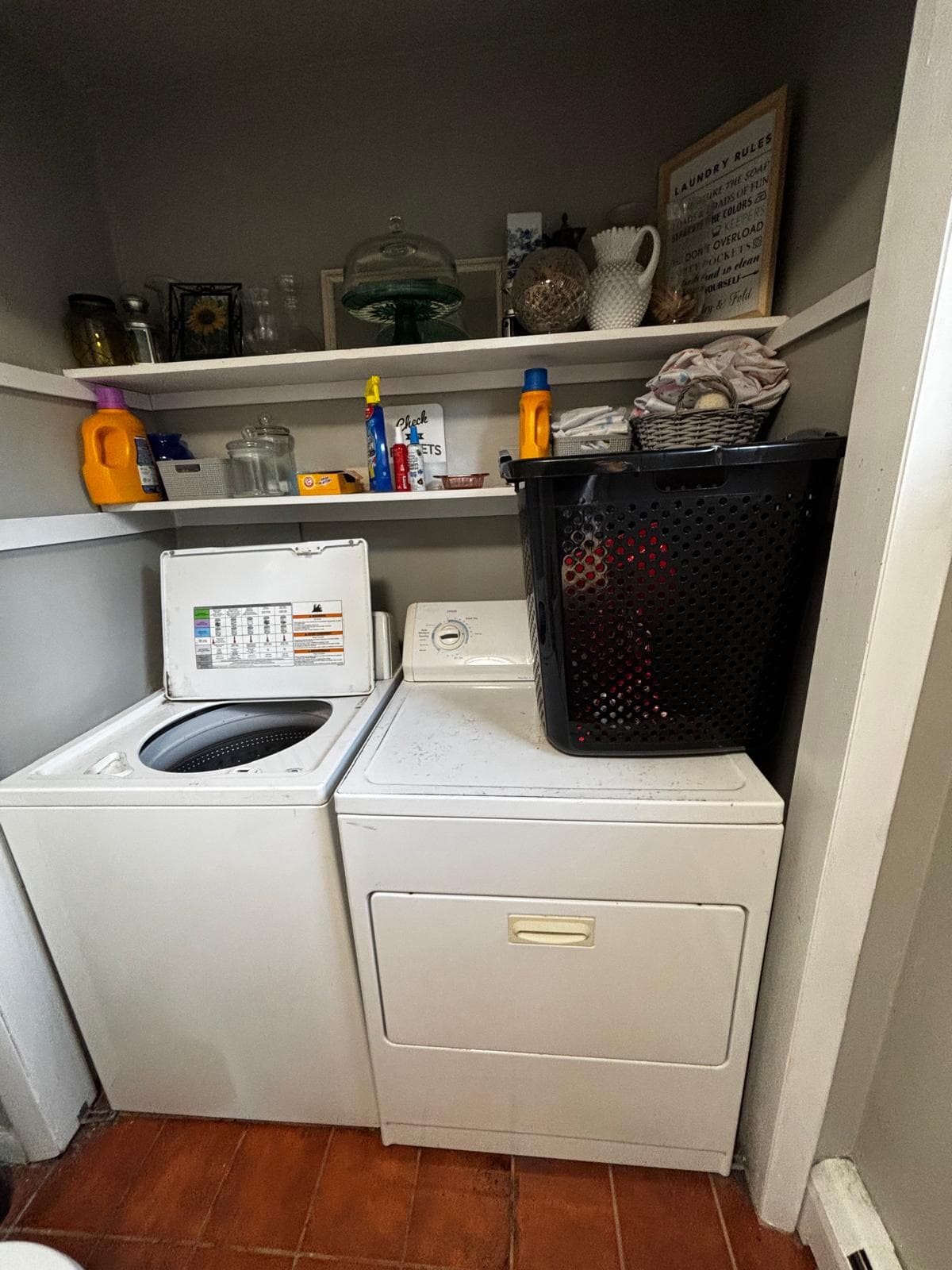 Top-load washing machine with lid open for inspection in Connecticut home laundry room — diagnosing spin cycle and agitator issue